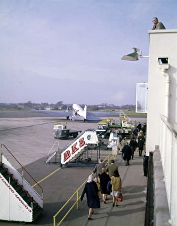 Scene at an airport, with passengers and aircraft Scene at an airport, with passengers and aircraft