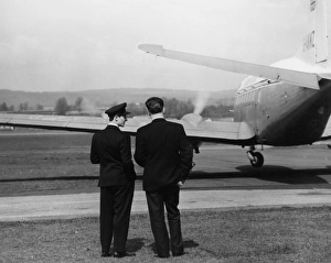 Scene at Exeter Airport, with two men and a plane Scene at Exeter Airport, with two men and a plane