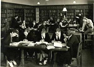 Schoolgirls in uniform studying in a library Schoolgirls in uniform studying in a library