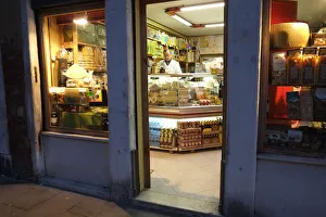 Shopkeeper in delicatessen at night, Via Garibaldi, Venice Shopkeeper in delicatessen at night, Via Garibaldi, Venice