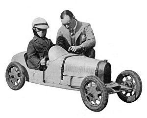 Sir Malcolm Campbell & Donald Campbell in toy motor car Sir Malcolm Campbell & Donald Campbell in toy motor car