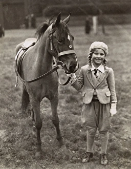 Smiling girl with her pony in a field Smiling girl with her pony in a field