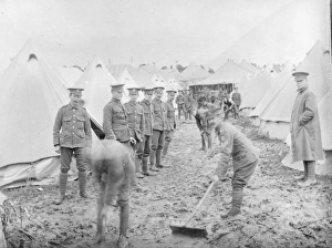 Soldiers cleaning up at a muddy training camp Soldiers cleaning up at a muddy training camp