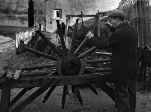 Wheelwright Fitting Spokes to a Wheel Print, 1930s