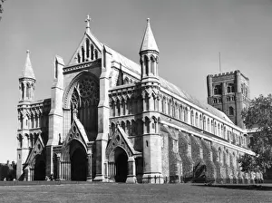 Prints of St. Albans Cathedral, Hertfordshire. A sacred site from ancient times, Benedictine monks built an abbey in St. Albans memory. Later rebuilt by the Normans. Date: 1930s Hertfordshire Prints: St Albans Cathedral Print, Hertfordshire, 1930s