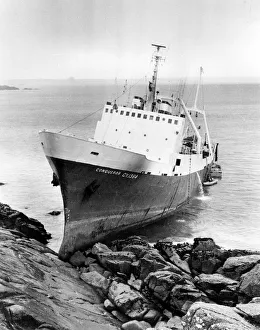 Stern trawler Conqueror on rocks at Mousehole, Cornwall Stern trawler Conqueror on rocks at Mousehole, Cornwall
