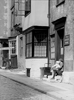 Street scene, children sitting on a step Street scene, children sitting on a step