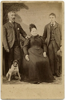 Studio portrait, family of three with terrier dog Studio portrait, family of three with terrier dog
