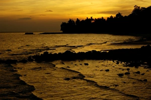 Sunset over a beach and rainforest on slopes of Sunset over a beach and rainforest on slopes of