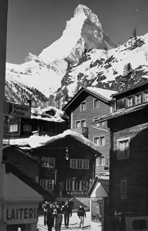 Prints of The Matterhorn towering over the ski resort of Zermatt, Switzerland. Date: 1960s Switzerland Prints: The Matterhorn Print, Zermatt, Switzerland 1960s