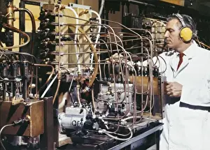 Laboratory Technician Prints: A technician adjusts delicate pipework