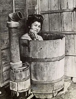 Traditional Japanese bathing in upright wooden tub Traditional Japanese bathing in upright wooden tub