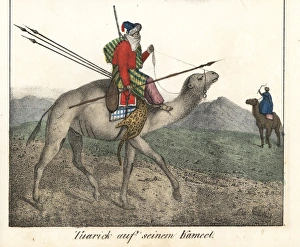 Tuareg man mounted on a camel carrying spears Tuareg man mounted on a camel carrying spears
