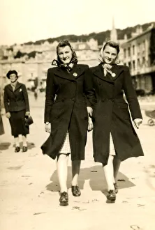 Twin sisters in matching headscarves, coats and skirts Twin sisters in matching headscarves, coats and skirts