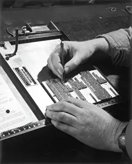 A typesetter at work, placing type on a forme rack in a print works