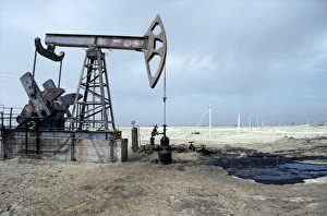 A typical oil-pump on an oil-well with a puddle A typical oil-pump on an oil-well with a puddle