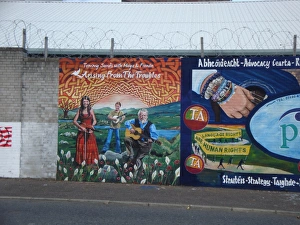 Wall mural of Tommy Sands with Moya & Fionan at Belfast Wall mural of Tommy Sands with Moya & Fionan at Belfast