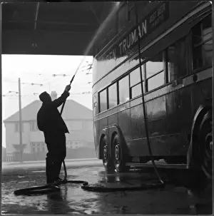 Bus Depot Print: A Man Hosing Down a Bus