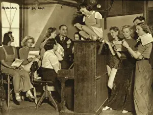 Prints of Eric Woodburn, seated at the piano, rehearses along with the girls of the Revudeville company at the Windmill Theatre, London. 1940 Theatre Prints: The Windmill Theatre, 1940: Rehearsal Print