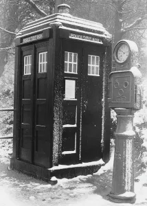 Prints of A Police Public Call Box, on a London street on a snowy day. The Metropolitan Police introduced police boxes throughout the London area between 1928 and 1937 Police Prints: A Mackenzie Trench Police Box in Snowy London Print