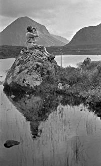 Woman with binoculars, Portree, Isle of Skye, Scotland Woman with binoculars, Portree, Isle of Skye, Scotland