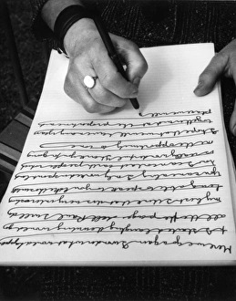 Woman doing automatic writing in a garden Woman doing automatic writing in a garden