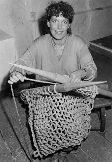 Woman knitting with six foot needles Woman knitting with six foot needles