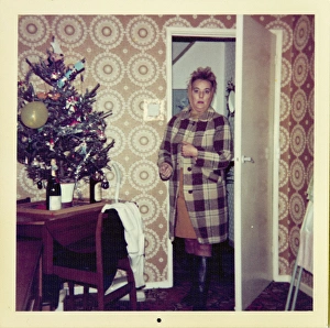 Woman looks surprised entering room decorated for Christmas Woman looks surprised entering room decorated for Christmas