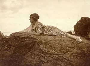 Woman lying on a rock at the seaside Woman lying on a rock at the seaside
