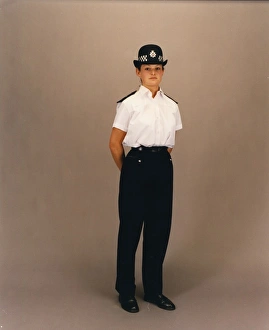 Woman police officer in white shirt and bowler hat, London Woman police officer in white shirt and bowler hat, London