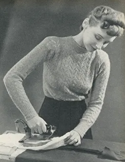 Woman pressing a seam under a damp cloth Woman pressing a seam under a damp cloth