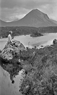 Woman on rock, Portree, Isle of Skye, Scotland Woman on rock, Portree, Isle of Skye, Scotland
