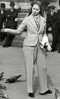 Woman in trouser suit feeding pigeons, Trafalgar Square Woman in trouser suit feeding pigeons, Trafalgar Square