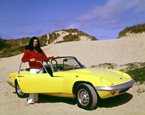 Woman with yellow sports car on a beach Woman with yellow sports car on a beach
