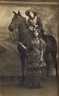 Two women in costume with horse in studio photo Two women in costume with horse in studio photo
