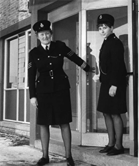 Two women police officers outside a police station Two women police officers outside a police station