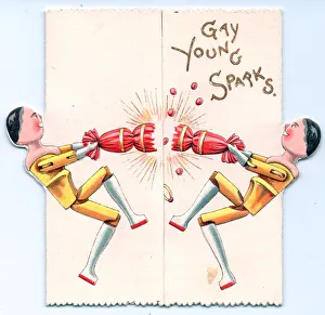 Two wooden dolls pulling a cracker on a greetings card Two wooden dolls pulling a cracker on a greetings card