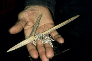 Wooden fishing hook on palm of a Siberian shaman/ Wooden fishing hook on palm of a Siberian shaman/