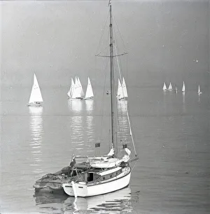 Yacht at rest with National 12 dinghies in twilight Yacht at rest with National 12 dinghies in twilight