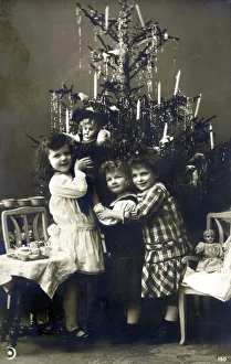 Three young Italian sisters by their Christmas Tree Three young Italian sisters by their Christmas Tree