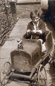 Young lad with a magnificent wooden toy car Young lad with a magnificent wooden toy car