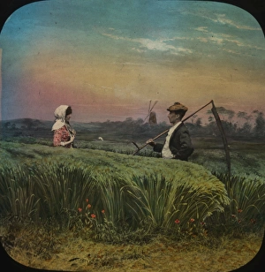 Young man carrying a scythe meets his girl amid the corn Young man carrying a scythe meets his girl amid the corn