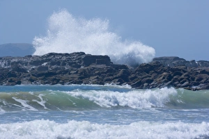 Blowhole - massive waves rushing up against cliffs creating an uprising fountain Blowhole - massive waves rushing up against cliffs creating an uprising fountain