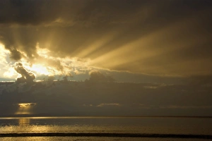 Thunderstorm over the ocean - dark clouds of a thunderstorm are approaching the beach at Thunderstorm over the ocean - dark clouds of a thunderstorm are approaching the beach at