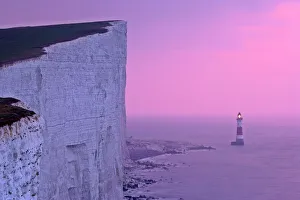 UK - lighthouse at Beachy Head with steep chalk cliffs at sunrise UK - lighthouse at Beachy Head with steep chalk cliffs at sunrise
