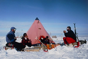 Antarctic research team relaxing outside tent Antarctic research team relaxing outside tent