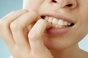 Prints of Anxiety. Woman biting her fingernails. This is a common sign of nervousness or anxiety. It can also be a habitual activity Images Dated 2004 August: Anxiety Anxiety Print: Woman Biting Her Fingernails