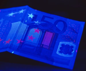 Prints of Banknote security. Euro banknote in ultraviolet light. This highlights security features intended to prevent fraud Images Dated 2004 July: Euro Banknote Print under Ultraviolet Light