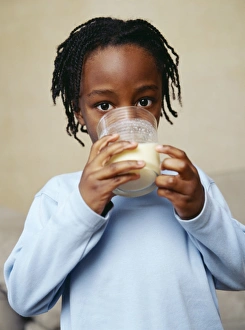 Prints of MODEL RELEASED. Drinking milk. Five-year-old boy drinking a glass of milk. Milk provides essential vitamins and minerals. It provides children with calcium for bones and fats for rapid growth Images Dated 2004 August: Boy drinking milk Print