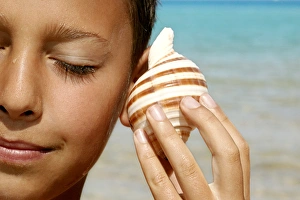 Beach Activities For Kids Prints: Boy listening to a shell